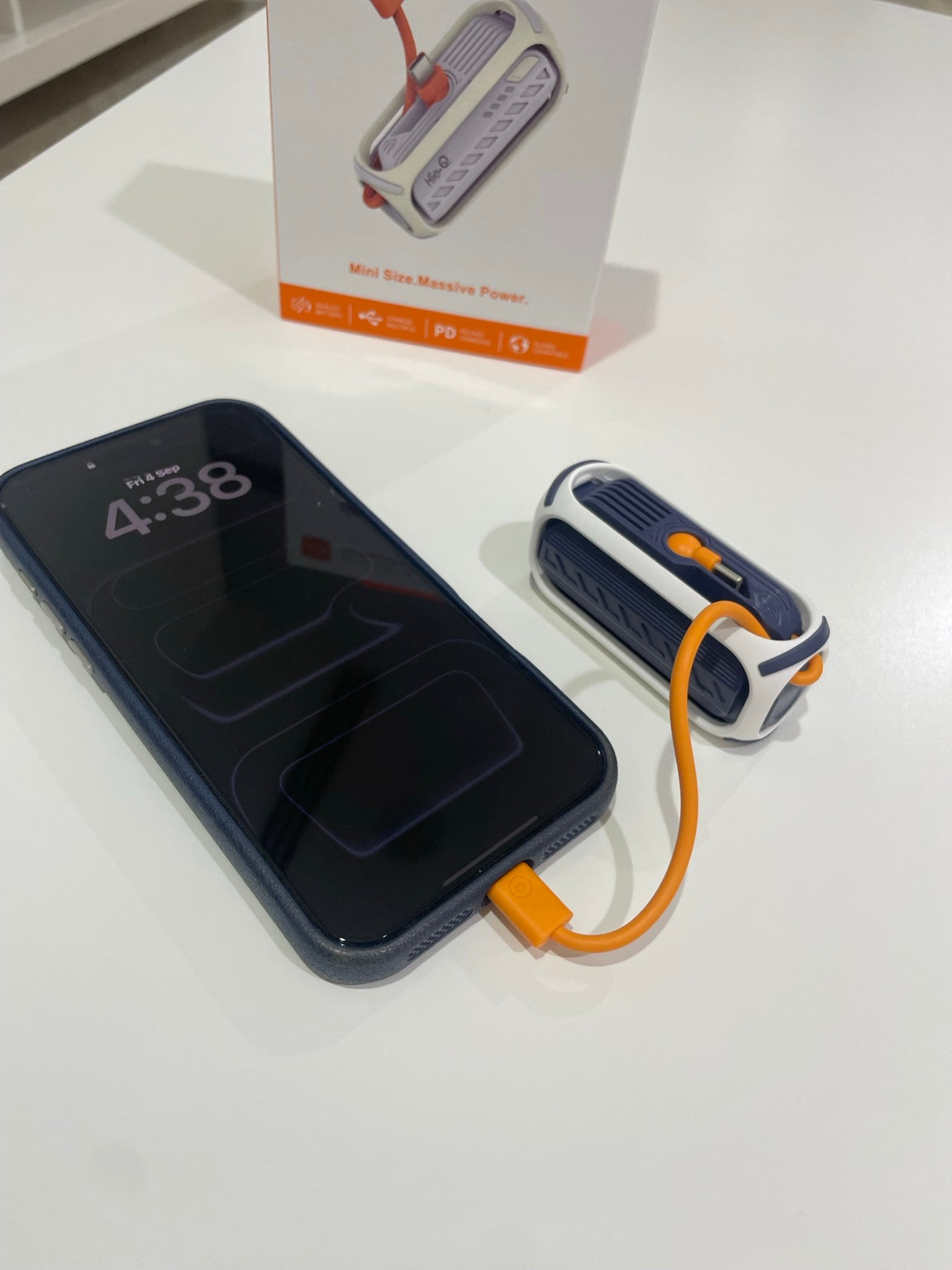 HieQ QuickMini 5K charging a phone with built-in USB-C cable